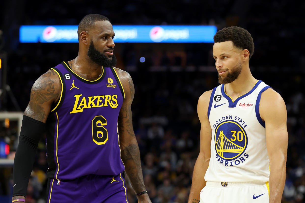 SAN FRANCISCO, CALIFORNIA - OCTOBER 18: LeBron James #6 of the Los Angeles Lakers speaks to Stephen Curry #30 of the Golden State Warriors during their game at Chase Center on October 18, 2022 in San Francisco, California. NOTE TO USER: User expressly acknowledges and agrees that, by downloading and or using this photograph, User is consenting to the terms and conditions of the Getty Images License Agreement. (Photo by Ezra Shaw/Getty Images)