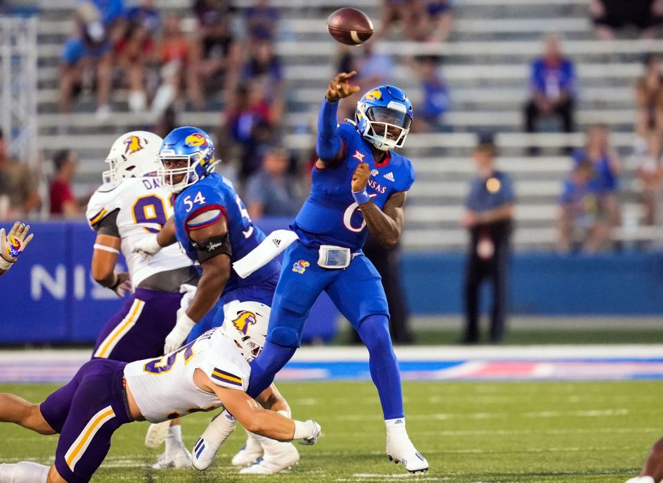 Kansas quarterback Jalon Daniels (6) throws a pass as he is hit by a Tennessee Tech defender during the first half of a Sept. 2 game at David Booth Kansas Memorial Stadium in Lawrence.