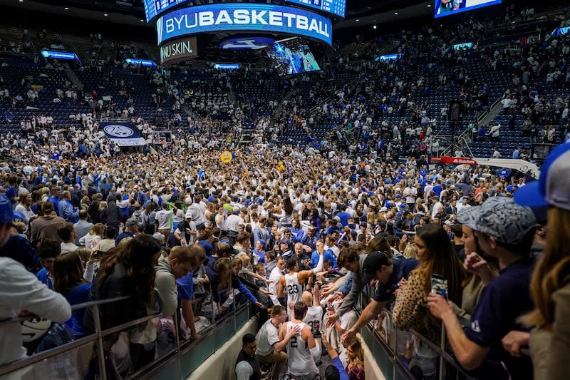 BYU players go back on the court to celebrate with fans after BYU toppled No. 2-ranked Gonzaga 91-78 at the Marriott Center.