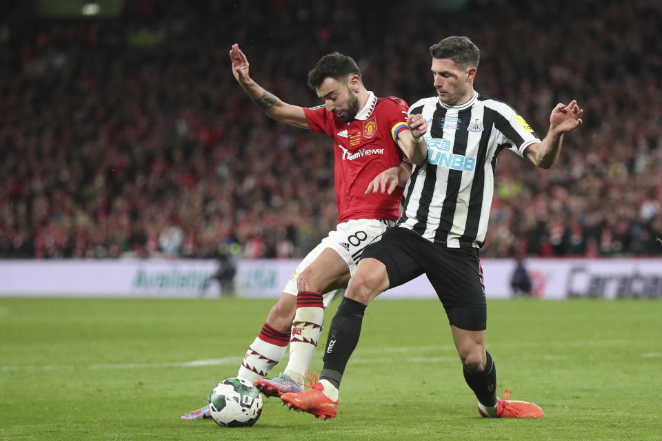 Newcastle's Fabian Schaer, right, fights for the ball with Manchester United's Bruno Fernandes during the English League Cup final soccer match between Manchester United and Newcastle United at Wembley Stadium in London, Sunday, Feb. 26, 2023. (AP Photo/Scott Heppell)