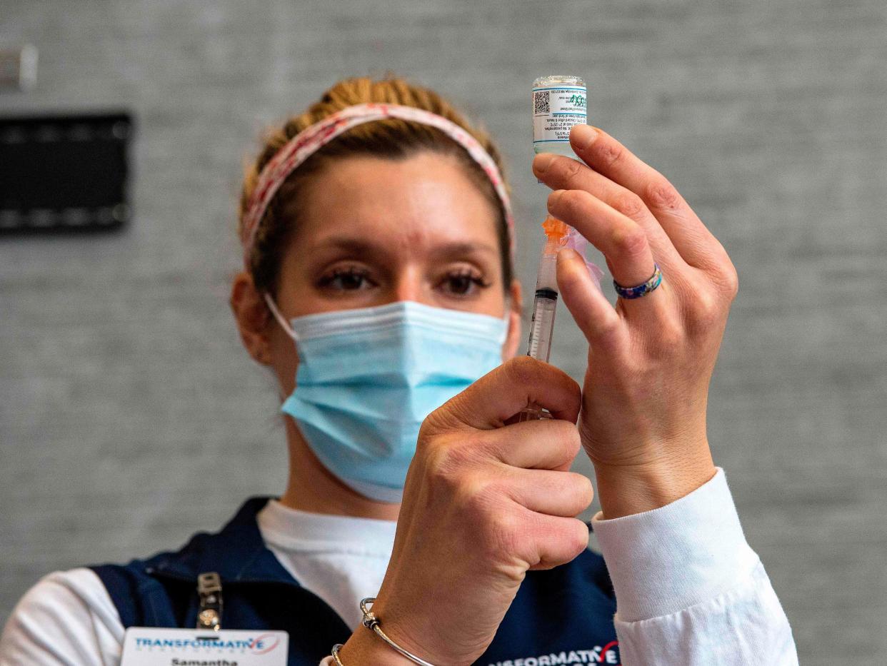 <p>A nurse prepares to deliver a Covid vaccine in Massachusetts </p> (AFP via Getty)