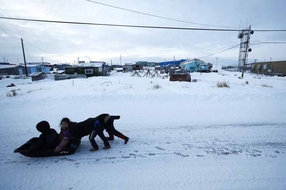 Children play in the snow Saturday, Jan. 18, 2020, in Toksook Bay, Alaska. The first Americans to be counted in the 2020 Census starting Tuesday, Jan. 21, live in this Bering Sea coastal village. The Census traditionally begins earlier in Alaska than the rest of the nation because frozen ground allows easier access for Census workers, and rural Alaska will scatter with the spring thaw to traditional hunting and fishing grounds. (AP Photo/Gregory Bull)