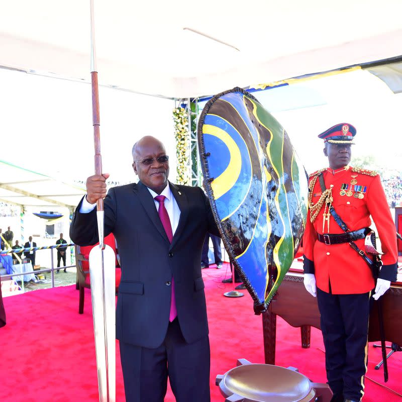 FILE PHOTO: FILE PHOTO: Tanzania's re-elected President John Pombe Magufuli holds a spear and shield from the elders after he was sworn-in for the second term at the Jamhuri stadium in Dodoma