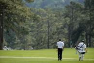 U.S. golfer Bubba Watson walks down the second fairway with his caddie Ted Scott (R) during the final round of the Masters golf tournament at the Augusta National Golf Club in Augusta, Georgia April 13, 2014. REUTERS/Mike Blake (UNITED STATES - Tags: SPORT GOLF)