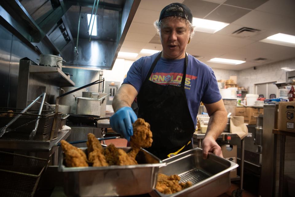 Kahlil Arnold, on the first day of reopening, temporarily, preps the fried chicken to serve to customers at Arnold's in Nashville, Tenn., Monday, Jan. 8, 2024.