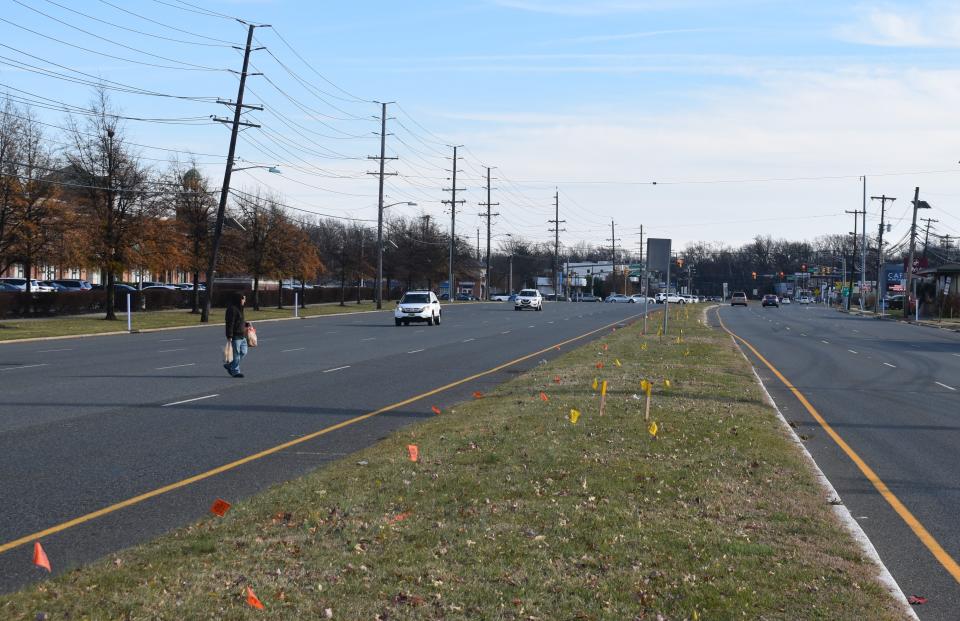 A pedestrian jaywalks Tuesday on Route 70 in Cherry Hill, the site of a fatal hit-and-run accident on Thanksgiving Day.