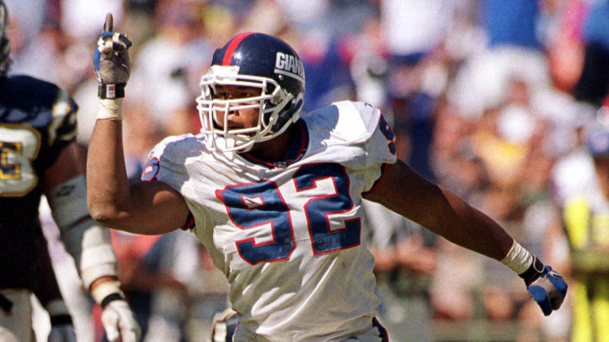 Mandatory Credit: Photo by Lenny Ignelzi/AP/Shutterstock (6496052a)STRAHAN New York Giants Michael Strahan does his imitation of San Diego Chargers' Junior Seau as he taunts the Chargers' bench after sacking San Diego quarterback Ryan Leaf in the second quarter of the Giants' 34-16 victory in San DiegoGIANTS CHARGERS, SAN DIEGO, USA.