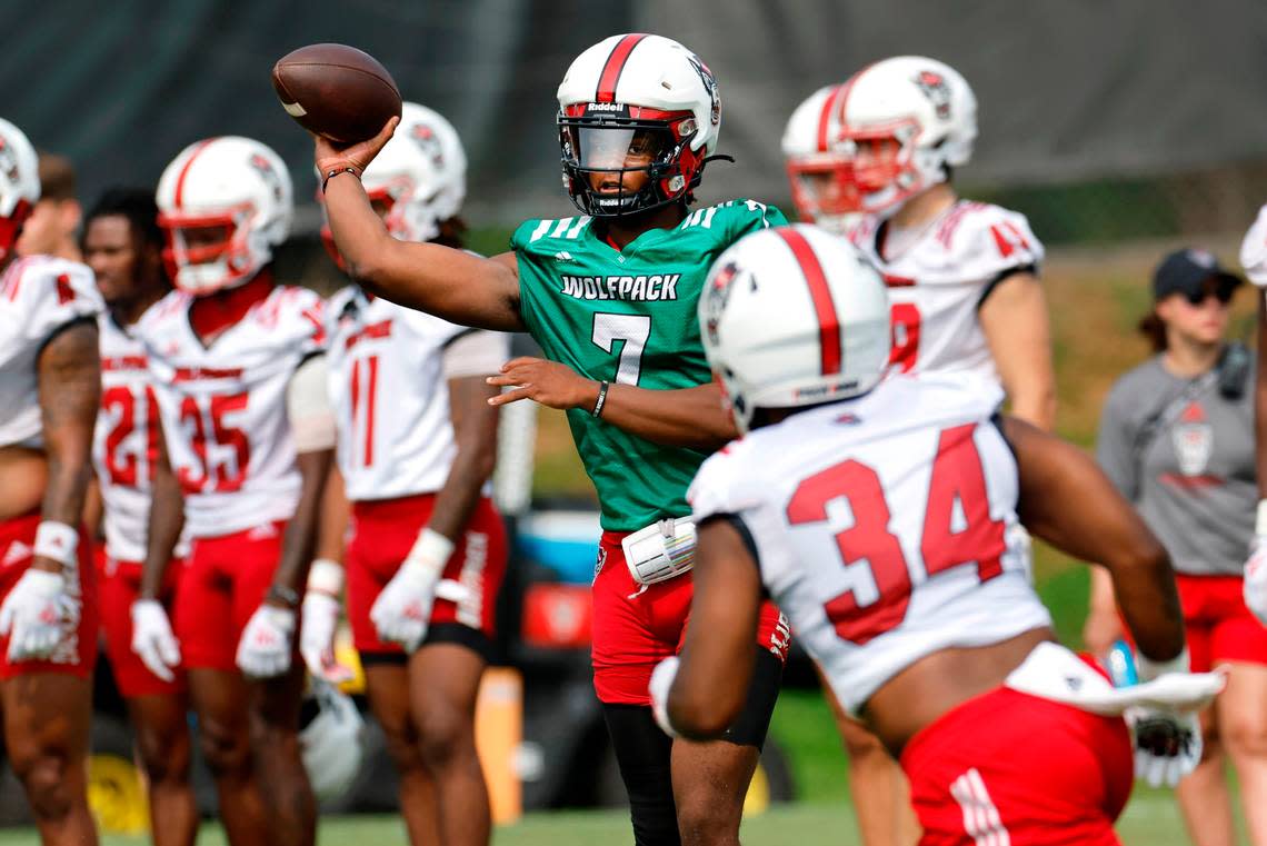 N.C. State quarterback MJ Morris (7) passes to Delbert Mimms III (34) during the Wolfpack’s first fall practice in Raleigh, N.C., Wednesday, August 2, 2023. Ethan Hyman/ehyman@newsobserver.com