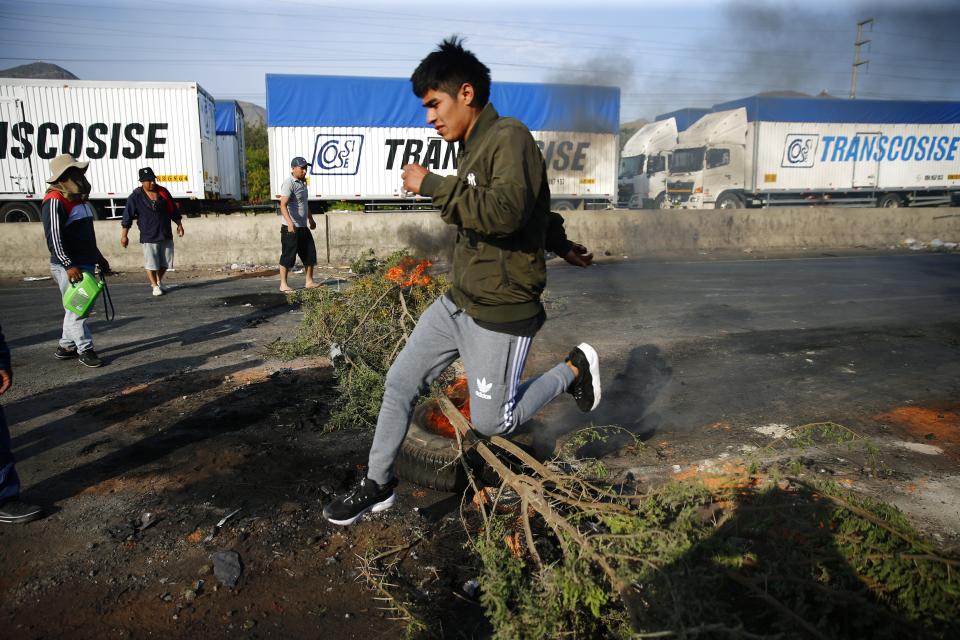 Supporters of ousted Peruvian President Pedro Castillo block the Pan-American North Highway to protest his detention in Viru, Peru, Thursday, Dec. 15, 2022. Peru's new government declared a 30-day national emergency on Wednesday amid violent protests following Castillo's ouster, suspending the rights of "personal security and freedom" across the Andean nation. (AP Photo/Hugo Curotto)