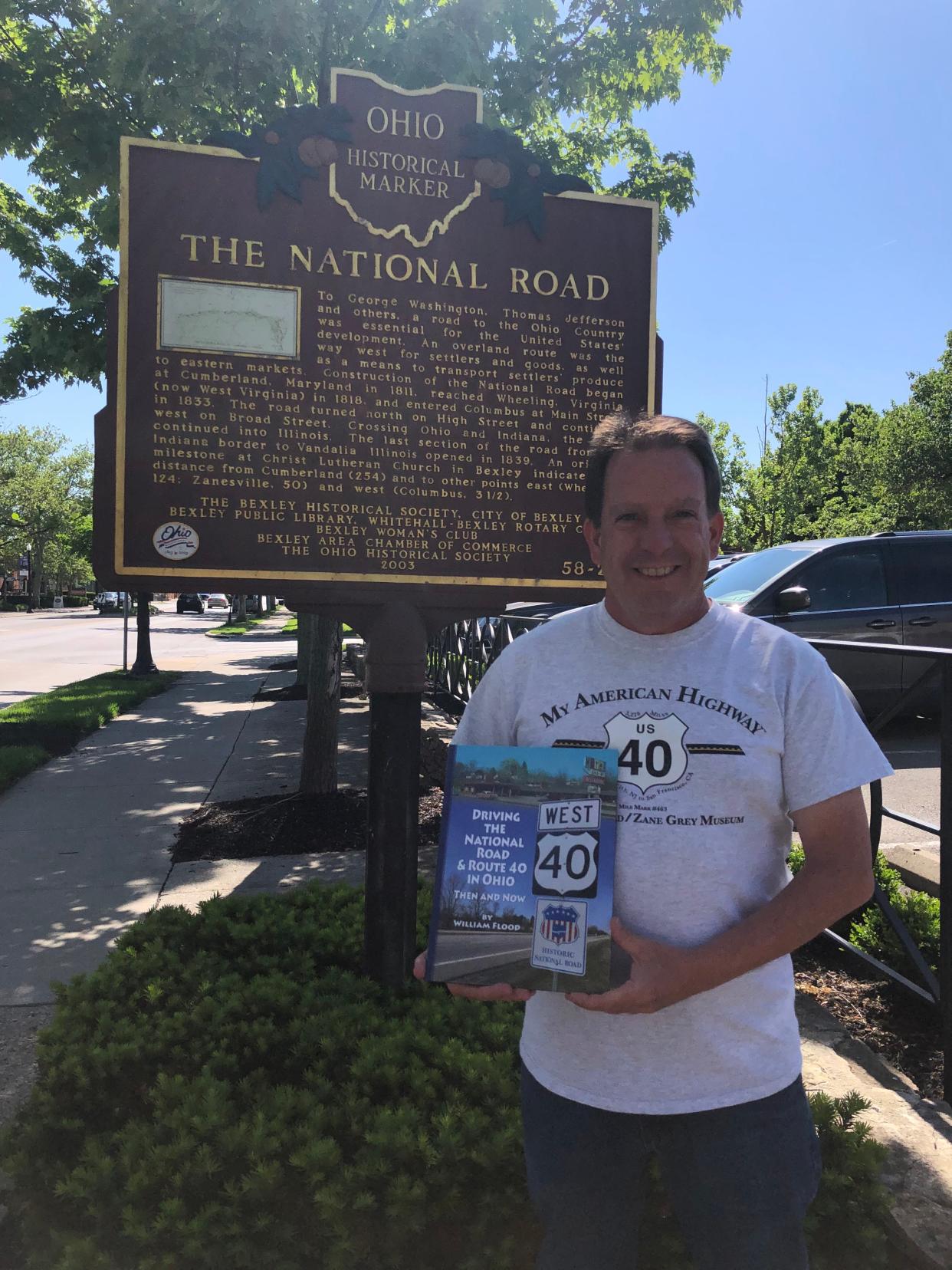 Ohio author William Flood stands in front of one of the historical markers along the National Road in Columbus.