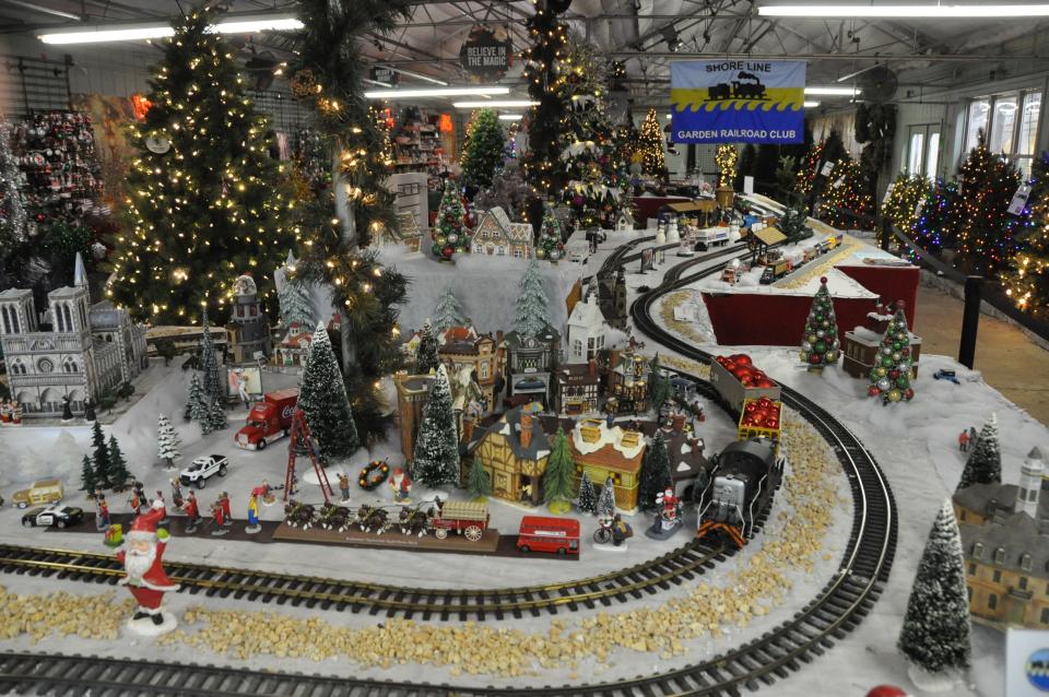 At Homestead Gardens in Smyrna, holiday trees and decorations are displayed in and around the model train layout designed by the Shore Line Garden Railroad Club.