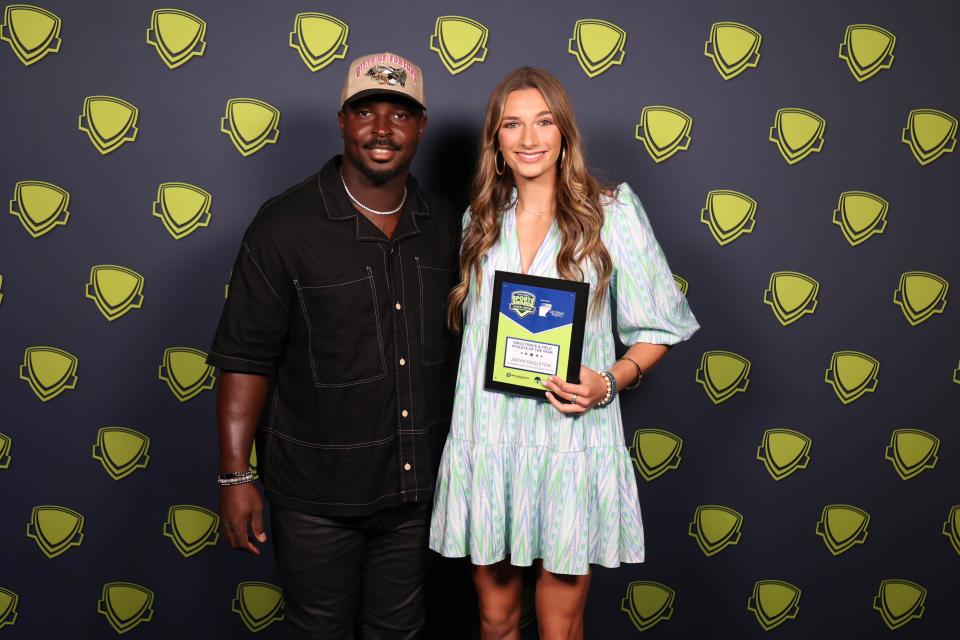 Jadyn Singleton of Savannah Christian, the Coastal Empire Girls Track and Field Athlete of the Year, with Sony Michel.