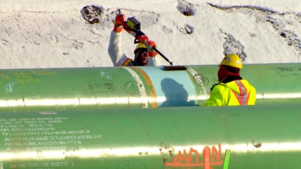 Crews connect two pieces of pipe near Edmonton in March 2020 as part of the Trans Mountain expansion project.