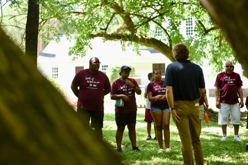 Bishop Gregory Smith (left) of Servants of Christ Ministries in Garner and his wife Kathy Smith (right) listen to historic interpreter Bill Bryant during a guided emnacipation tour at the Stagville State Historic Site on Saturday, June 18, 2022