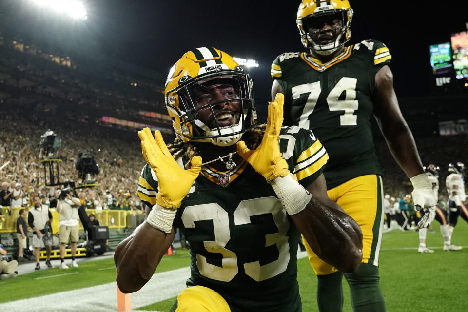 The Green Bay Packers running back Aaron Jones (33) celebrate after taking an 8-yard touchdown pass against the Bears.  (Photo by Associated Press/Morri Gash)
