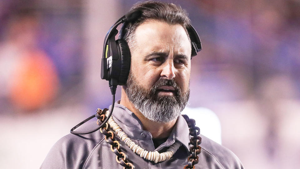 Pictured here, American football coach Nick Rolovich looks frustrated during a college game.