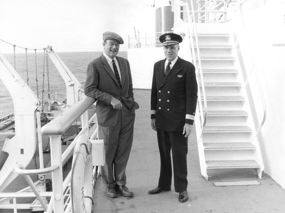 John Wayne, with Commodore John Anderson, on the sports deck of the SS United States.