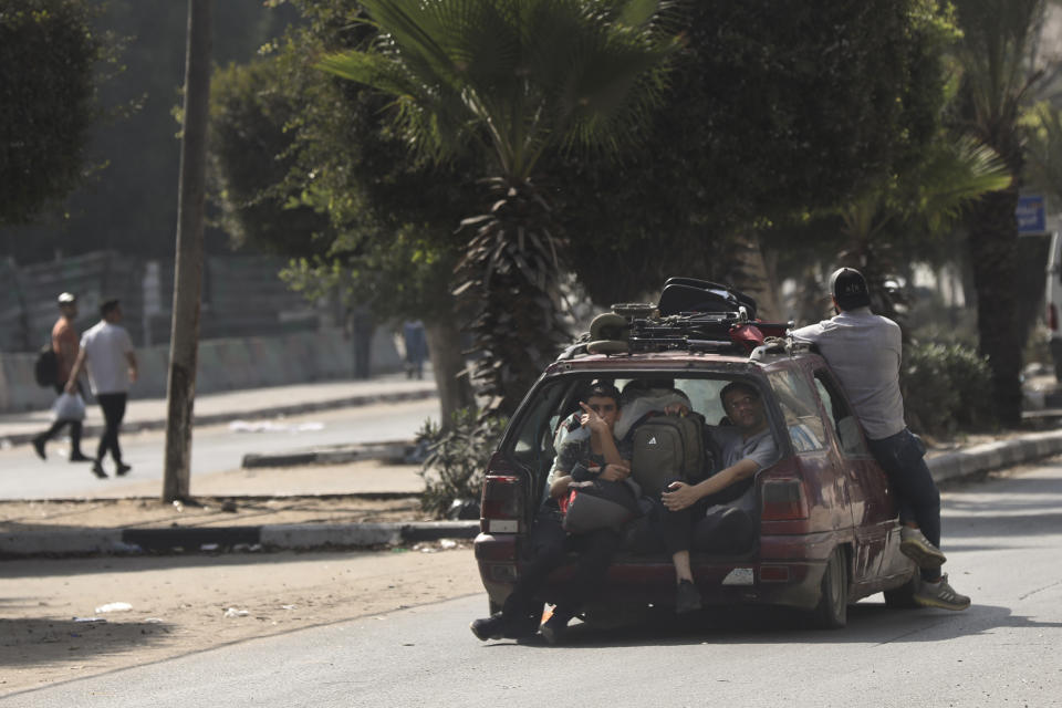 Palestinians ride a car in the al-Rimal neighbourhood, central Gaza City while fleeing to the southern Gaza Strip, Wednesday, Nov. 8, 2023. (AP Photo/Abed Khaled)