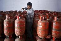 A worker arranges filled Liquefied Petroleum Gas (LPG) cylinders at a distribution centre at Dujana village in Noida, on the outskirts of New Delhi October 7, 2015. REUTERS/Anindito Mukherjee