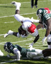Rutgers running back Aaron Young (4) falls over Michigan State cornerback Chris Jackson (12) during the first half of an NCAA college football game, Saturday, Oct. 24, 2020, in East Lansing, Mich. (AP Photo/Carlos Osorio)