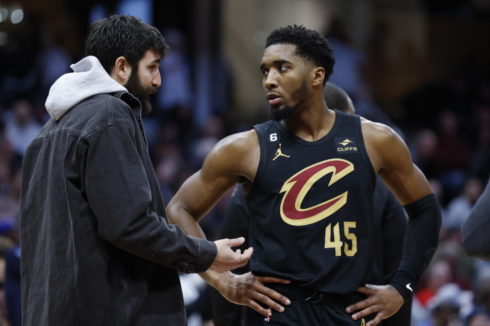 FILE - Cleveland Cavaliers guard Donovan Mitchell (45) talks with injured guard Ricky Rubio during the second half of an NBA basketball game against the Brooklyn Nets, Monday, Dec. 26, 2022, in Cleveland. While Ricky Rubio's retirement from the NBA caught many around the league off guard, Donovan Mitchell sensed it was coming. Mitchell spent two seasons with Rubio in Utah and one in Cleveland. (AP Photo/Ron Schwane, File)