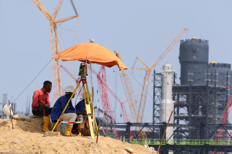 FILE PHOTO: Workers sit at a construction site of the Dangote Refinery in Ibeju Lekki district