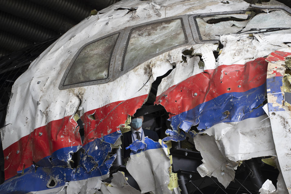 FILE- In this Wednesday, May 26, 2021, file photo presiding judge Hendrik Steenhuis is seen inside the cockpit as he and other trial judges and lawyers view the reconstructed wreckage of Malaysia Airlines Flight MH17, at the Gilze-Rijen military airbase, southern Netherlands. The trial in absentia in a Dutch courtroom of three Russians and a Ukrainian charged in the downing of Malaysia Airlines flight MH17 in 2014 moves to the merits phase, when judges and lawyers begin assessing evidence. (AP Photo/Peter Dejong, File)
