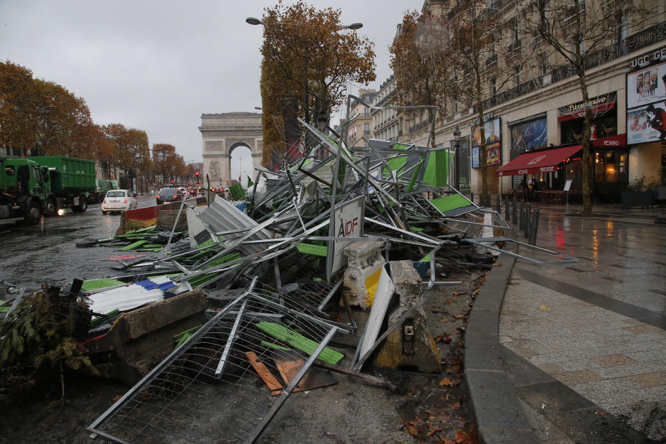 A barricade lays on the side at the Champs Elysees avenue in Paris, France, Sunday, Nov 25, 2018, in the aftermath of a protest against the rising of the fuel taxes . French President Emmanuel Macron has condemned violence by protesters at demonstrations against rising fuel taxes and his government. (AP Photo/Michel Euler)