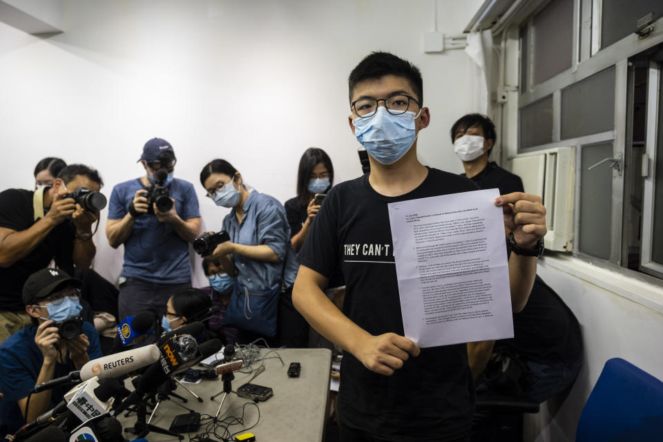 Joshua Wong, pro-democracy activist and disqualified candidate in the upcoming Legislative Council election, poses for a photograph with a copy of his prepared speech during a news conference in Hong Kong, China, on Friday, July 31, 2020. | Chan Long Hei/Bloomberg via Getty Images