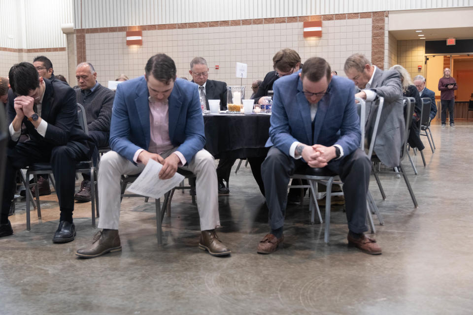 A group of men bow their head in prayer Tuesday morning at the 34th annual Amarillo Community Prayer Breakfast at the Amarillo Civic Center.