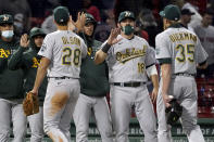 Oakland Athletics, including Mitch Moreland (18), congratulate each other after a 3-2 win over the Boston Red Sox in a baseball game Tuesday, May 11, 2021, in Boston. (AP Photo/Mary Schwalm)