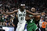 Milwaukee Bucks' Jrue Holiday fouls Boston Celtics' Jaylen Brown during the second half of Game 3 of an NBA basketball Eastern Conference semifinals playoff series Saturday, May 7, 2022, in Milwaukee. The Bucks won 103-101 to take a 2-0 lead in the series. (AP Photo/Morry Gash)