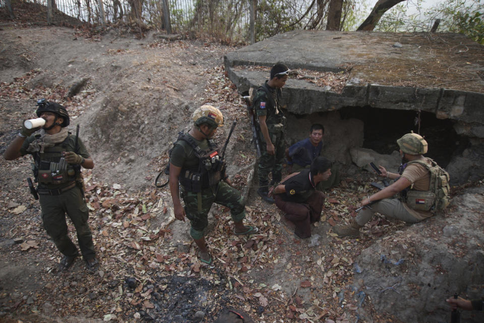 Members of the Karen National Liberation Army and People’s Defense Force examine two arrested soldiers after they captured an army outpost, in the southern part of Myawaddy township in Kayin state, Myanmar, March 11, 2024. (AP Photo/METRO)