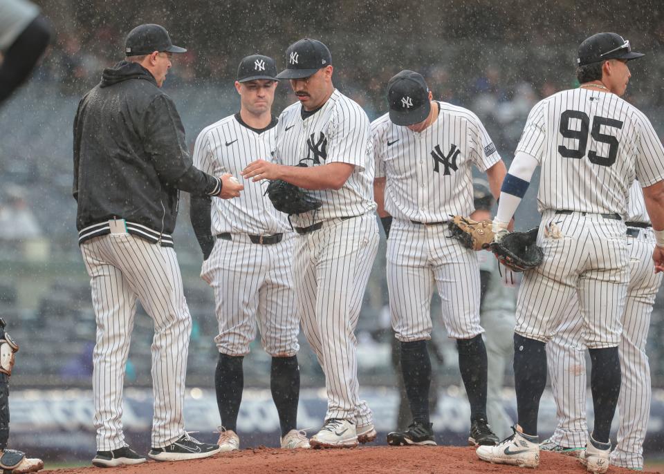 May 5, 2024; Bronx, New York, USA; New York Yankees starting pitcher Nestor Cortes (65) hands the ball to manager Aaron Boone (17) after being relieved during the seventh inning against the Detroit Tigers at Yankee Stadium. Mandatory Credit: Vincent Carchietta-USA TODAY Sports