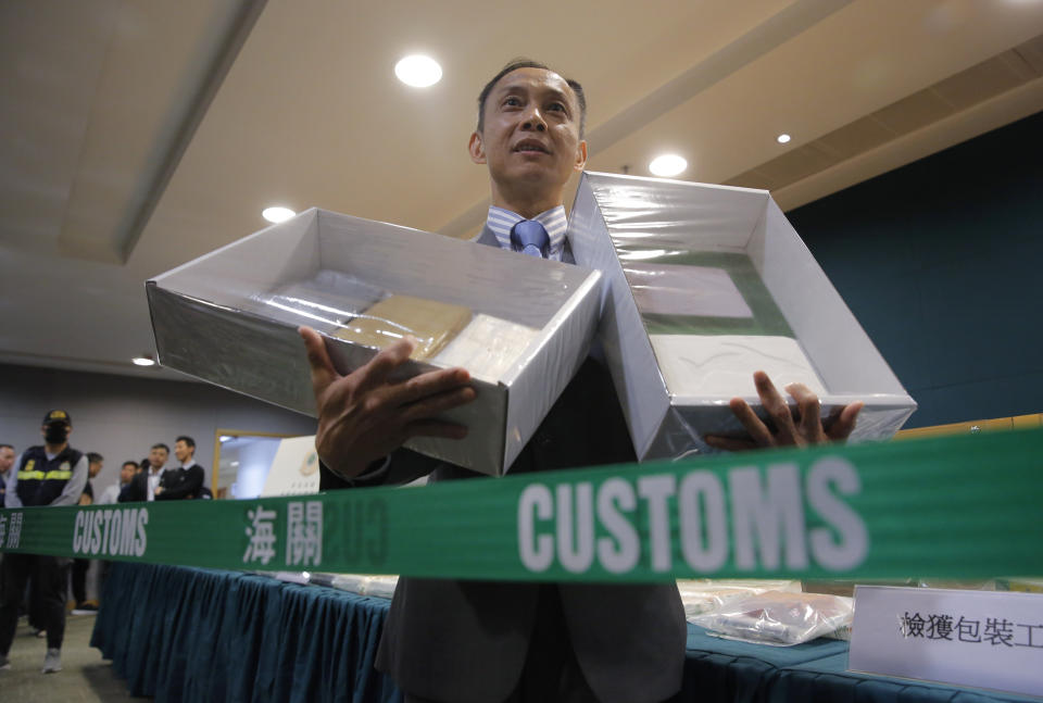 Head of Customs Drug Investigation Bureau Hui Wai-ming holds the seized cocaine during a news conference in Hong Kong, Thursday, April 4, 2019. A haul of cocaine with an estimated market value of $13 million has been seized in Hong Kong, customs agents said Thursday.(AP Photo/Kin Cheung)