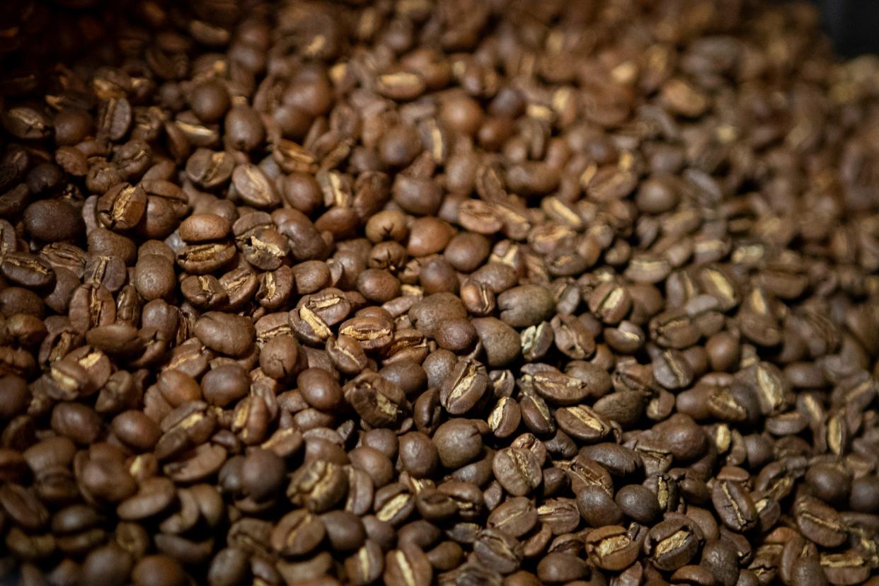 Coffee beans exit the roaster at Equiano Coffee Company in Eugene.