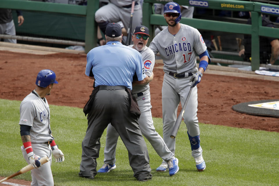 Chicago Cubs manager Joe Maddon, center, yells toward the Pittsburgh Pirates dugout as he is restrained by umpire Joe West and Cubs' Kris Bryant (17) during the fourth inning of a baseball game in Pittsburgh, Thursday, July 4, 2019. Maddon was ejected. (AP Photo/Gene J. Puskar)