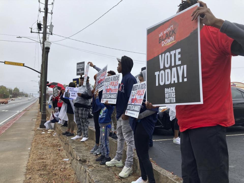 Activists rally for voting rights at the end of a Black church tradition known as "Souls to the Polls" event in Decatur, Ga., Sunday, Oct. 30, 2022. (AP Photo/Sudhin Thanawala)