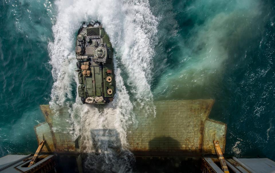 Arabian Gulf, August 24, 2014 - Marines aboard an amphibious assault vehicle (AAV) exit the deck of the amphibious assault ship USS Bataan (LHD 5).