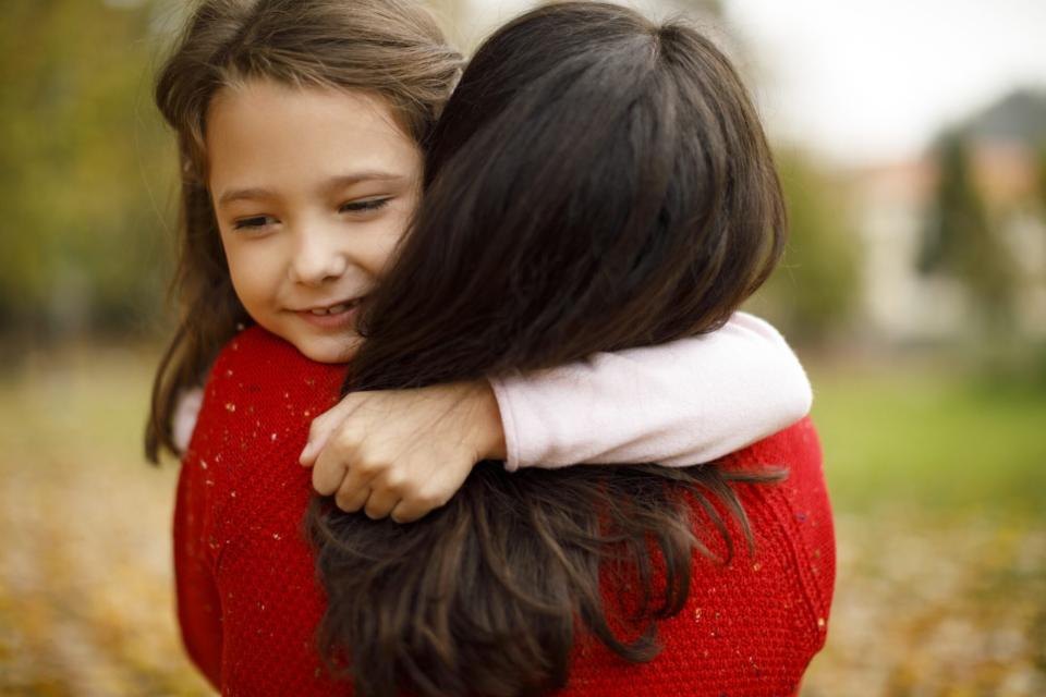 An image of a woman hugging a child.