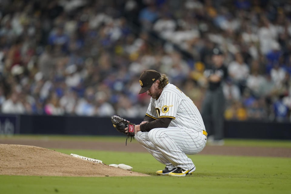 San Diego Padres relief pitcher Pierce Johnson takes a moment before facing the first Los Angeles Dodgers batter during the sixth inning of a baseball game Thursday, Sept. 29, 2022, in San Diego. (AP Photo/Gregory Bull)