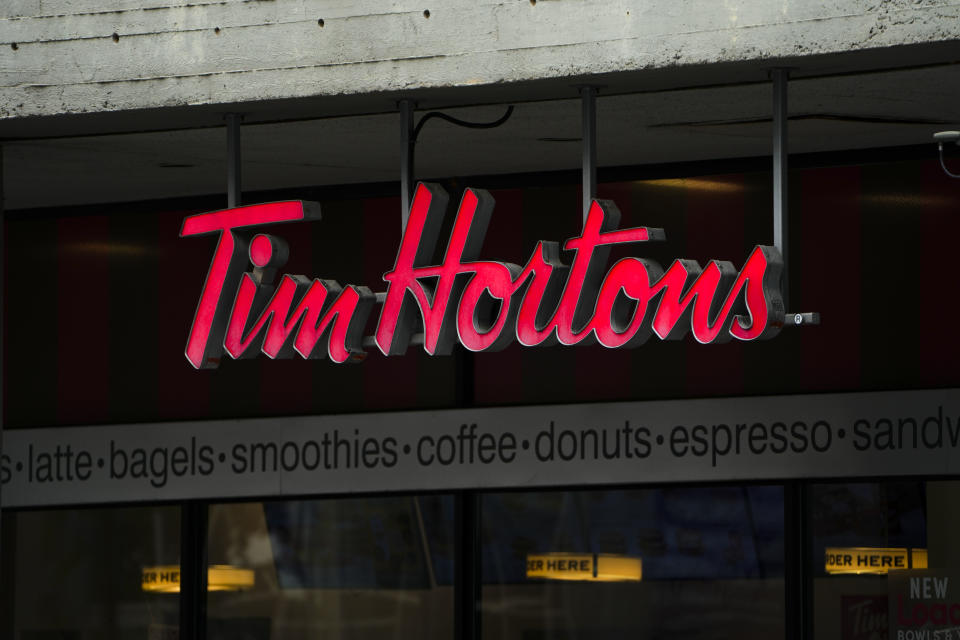 Tim Hortons signage is pictured in Ottawa on Wednesday Sept. 7, 2022. Tim Hortons&#39; parent company recorded higher sales and profit in its most recent quarter despite &#39;macroeconomic pressures&#39; weighing on the restaurant industry. THE CANADIAN PRESS/Sean Kilpatrick