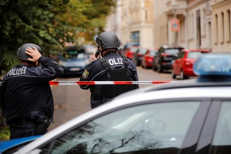 Police officers are seen at the site of a shooting in Halle