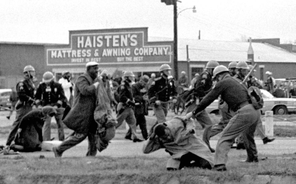 In this March 7, 1965 file photo, state troopers use clubs against participants of a civil rights voting march in Selma, Ala. At foreground right, John Lewis, chairman of the Student Nonviolent Coordinating Committee, is beaten by a state trooper. The day, which became known as "Bloody Sunday," is widely credited for galvanizing the nation's leaders and ultimately yielded passage of the Voting Rights Act of 1965.