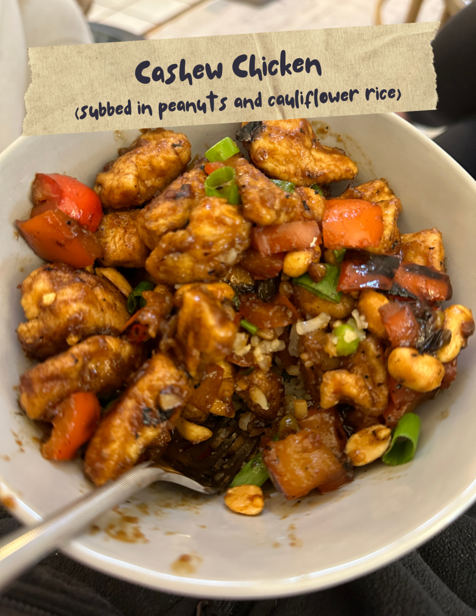 Bowl of cashew chicken with peanuts, cauliflower rice, bell peppers, and green onions. Text above reads: "Cashew Chicken (subbed in peanuts and cauliflower rice)."