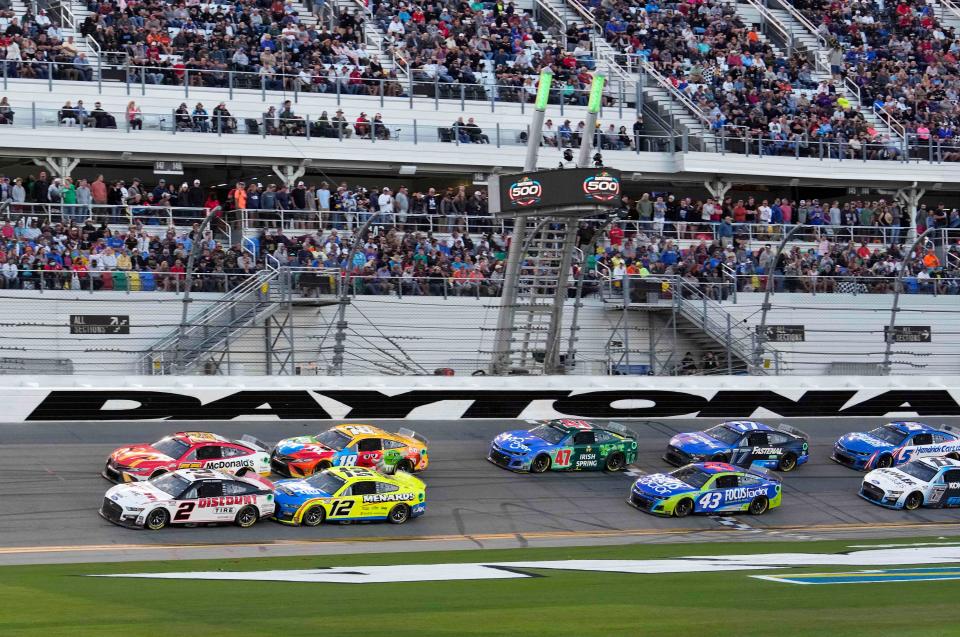 Austin Cindric (2), getting pushed by Penske teammate Ryan Blaney (12), won the 2022 Daytona 500.