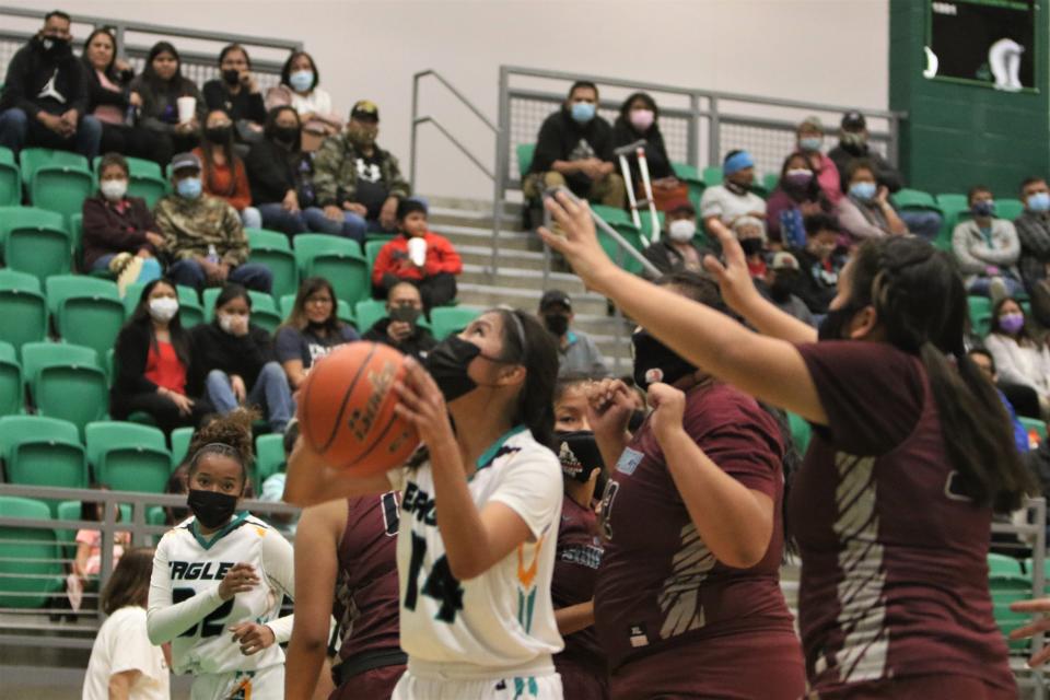 Navajo Prep's Amber Garcia (14) looks to go up for a basket while surrounded by Shiprock defenders in the second quarter of a girls basketball game Tuesday, Nov. 30, 2021 inside the Scorpion Arena at Farmington High School