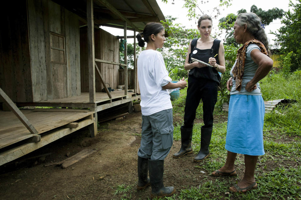 In this undated photo released on Sunday, April 22, 2012 by the United Nations High Commissioner for Refugees, UNHCR Special Envoy Angelina Jolie, center, meets with 71-year-old Gerardina, right, in the village of Barranca Bermeja. After a decade of promoting refugee causes around the world, Jolie herself has been promoted. The United Nations refugee agency has elevated the Hollywood star from being a goodwill ambassador to a special envoy, a role that will see her represent the organization to governments and diplomats. (AP Photo/ Jason Tanner, UNHCR via PA) EDITORIAL USE ONLY, ONE TIME USE ONLY, NO SALES, MANDATORY CREDIT, UNITED KINGDOM OUT, NO SALES, NO ARCHIVE