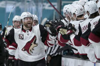 Arizona Coyotes right wing Phil Kessel (81) celebrates with teammates after scoring a goal against the San Jose Sharks during the third period of an NHL hockey game Friday, May 7, 2021, in San Jose, Calif. Arizona won 5-2. (AP Photo/Tony Avelar)