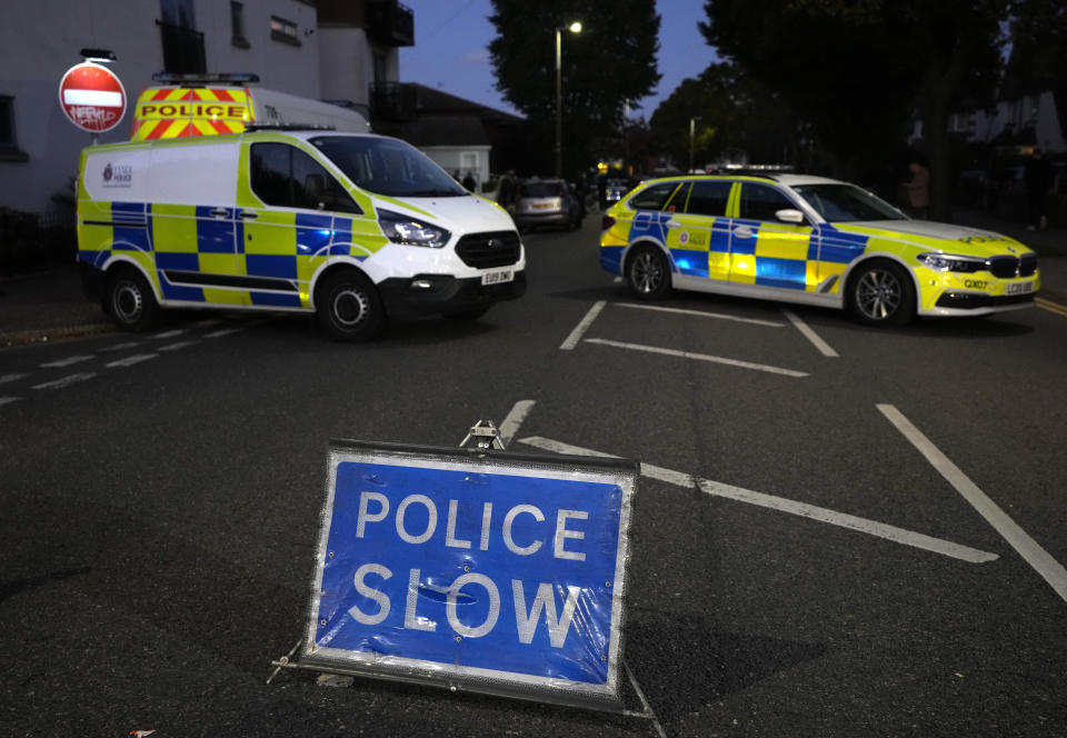 Police officers block a road near the Belfairs Methodist Church in Eastwood Road North, where British Conservative lawmaker David Amess died after being stabbed at a constituency surgery, in Leigh-on-Sea, Essex, England, Friday, Oct. 15, 2021. Police gave no immediate details on the motive for the killing of 69-year-old Conservative lawmaker Amess and did not identify the suspect, who was being held on suspicion of murder. (AP Photo/Kirsty Wigglesworth)